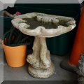 L06. Concrete dolphin base birdbath with shell-shaped top. 